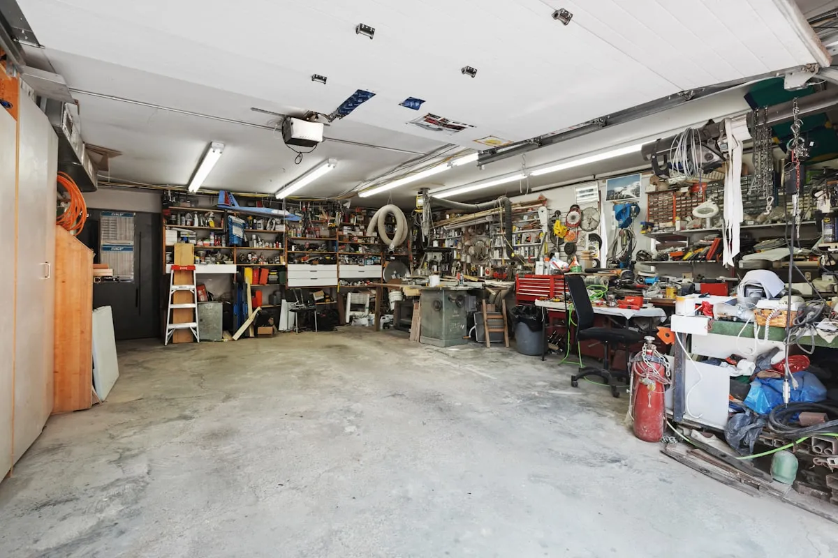 A garage packed wall to wall with clutter and tools